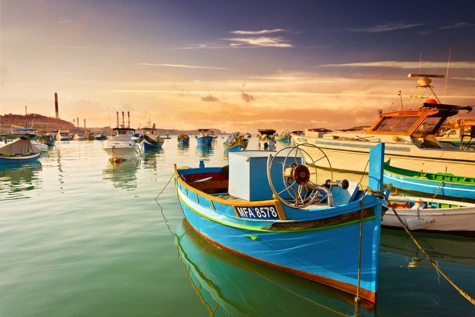 Luzzu fishing boats glow in the sunset