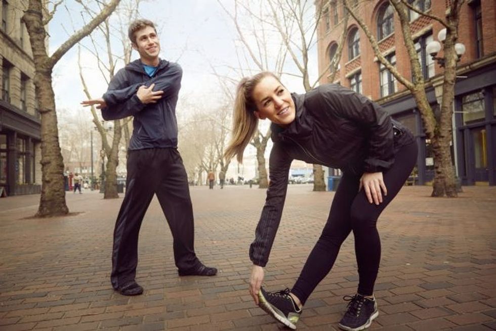 Male and female runners warming up on tree lined street, Pioneer Square, Seattle, USA