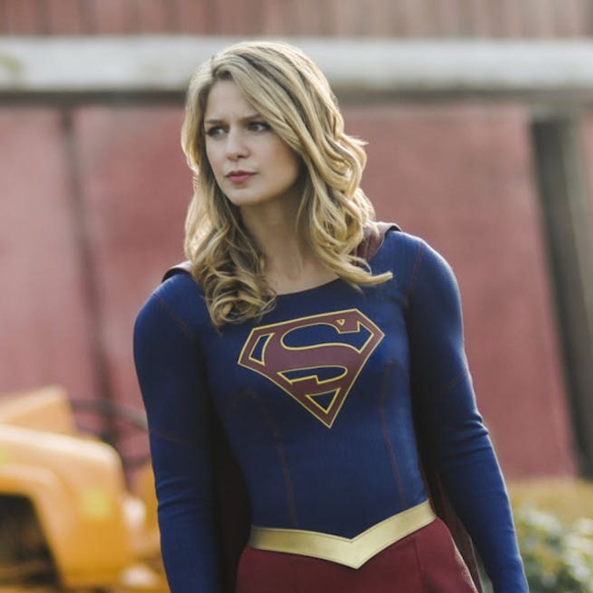 melissa benoist as female superhero supergirl in a red and blue uniform