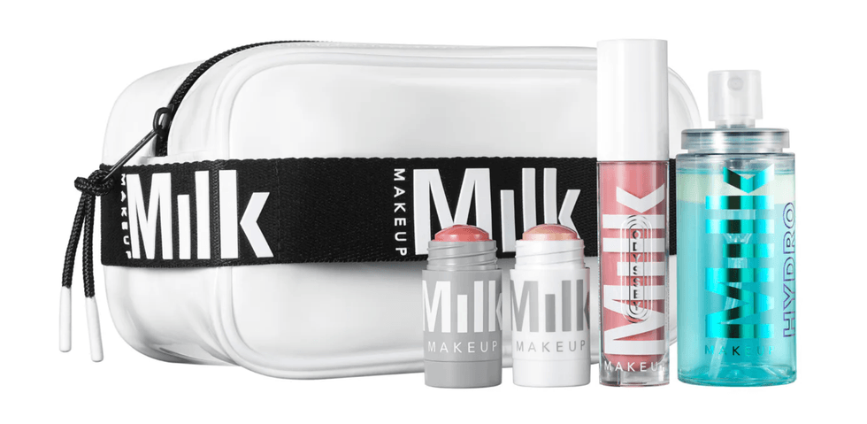 Milk Makeup set with bag, lip gloss, creams, and spray bottle.