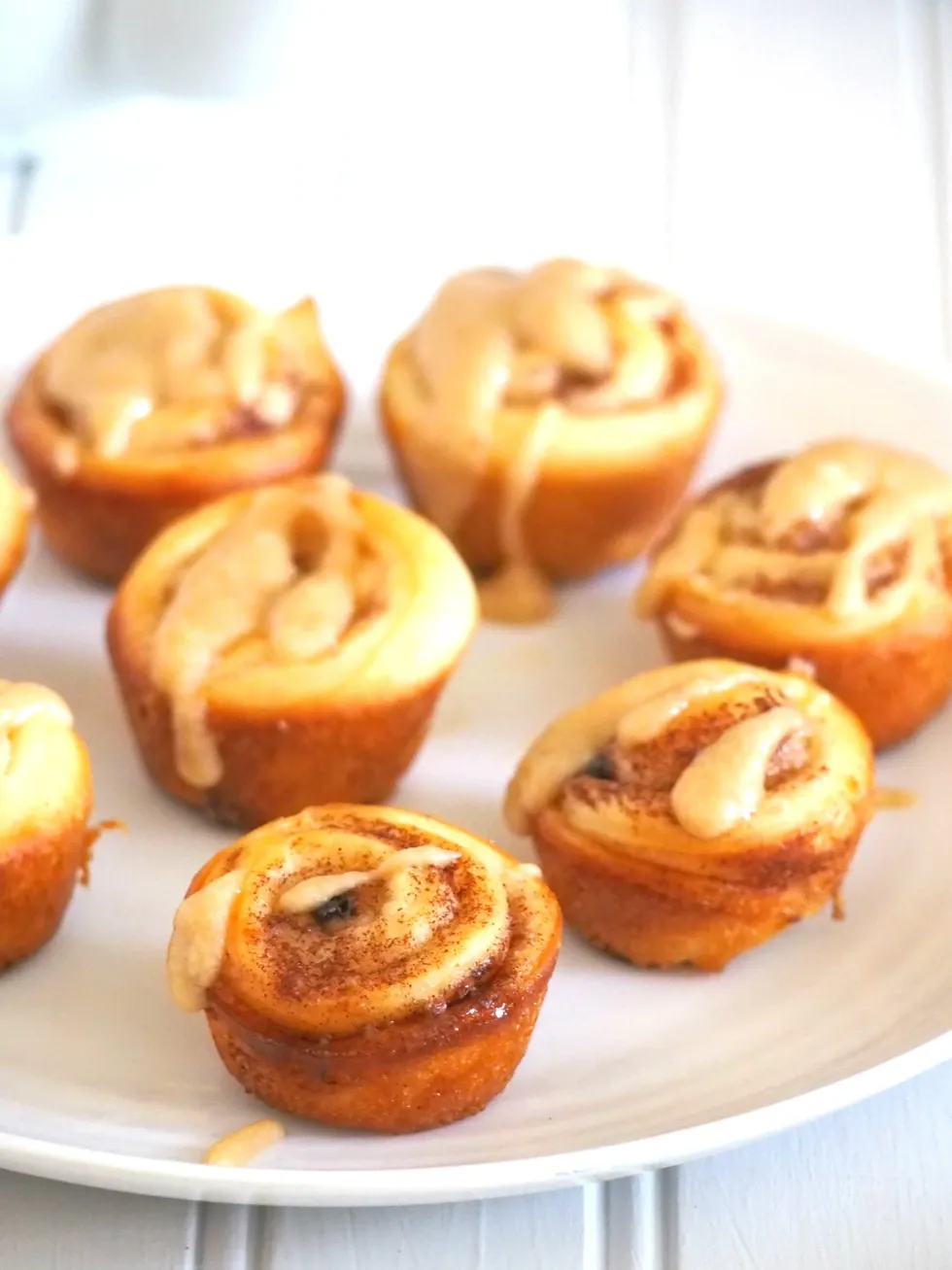 Mini cinnamon rolls are on a plate.