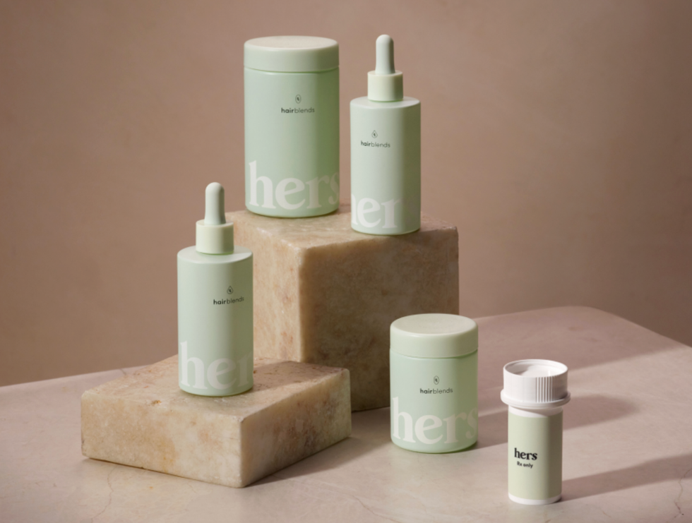 Mint green haircare bottles on marble blocks, with "hers" branding visible.