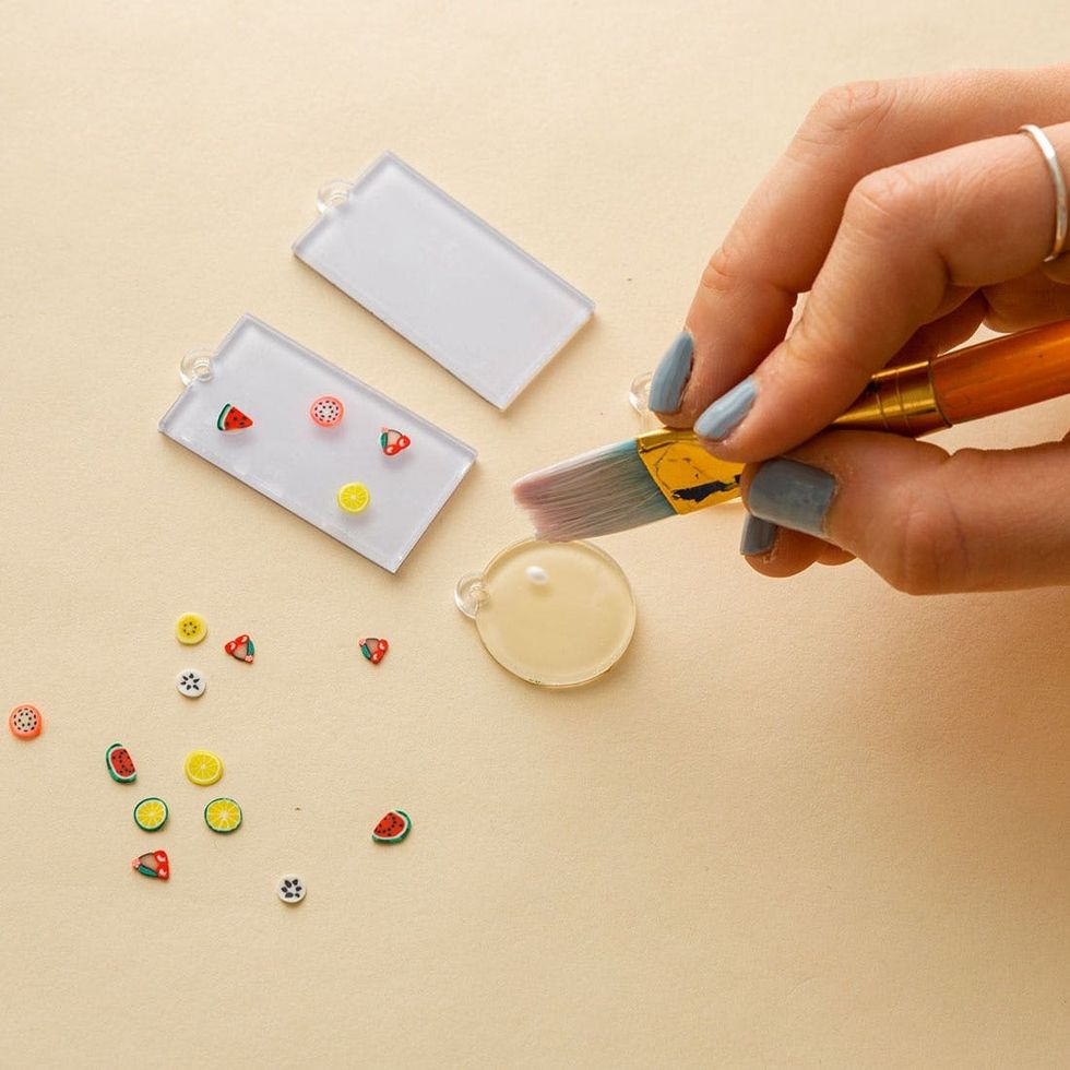 model attaches the fruit to the acrylic with modpodge