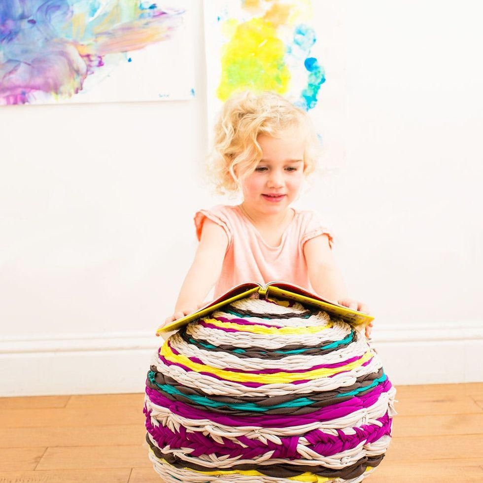 model reading a book on the rainbow DIY Woven Floor Pouf