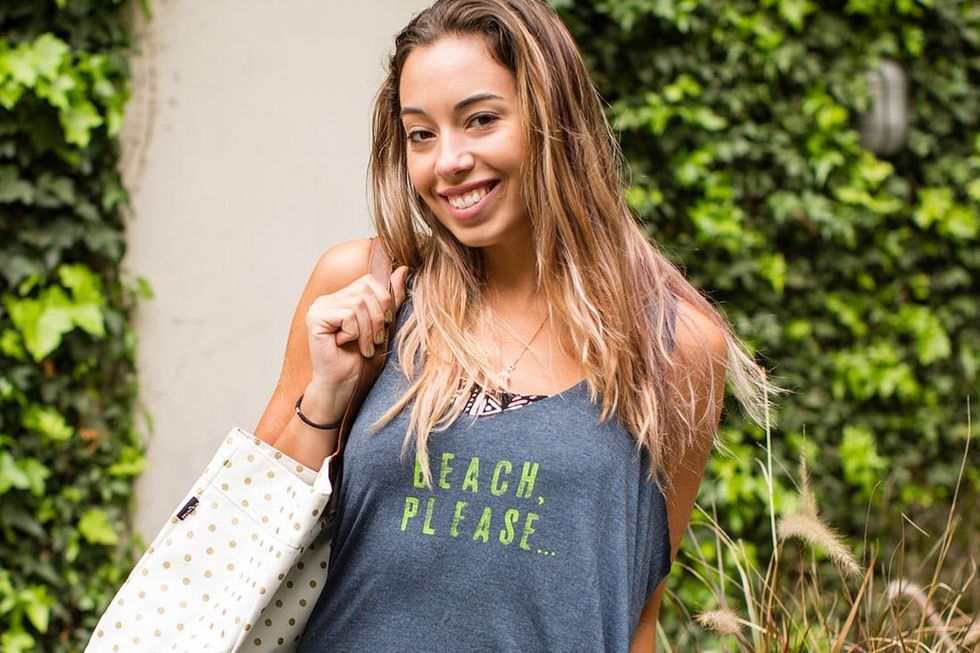 model wears gray Beach_cover_up with green writing