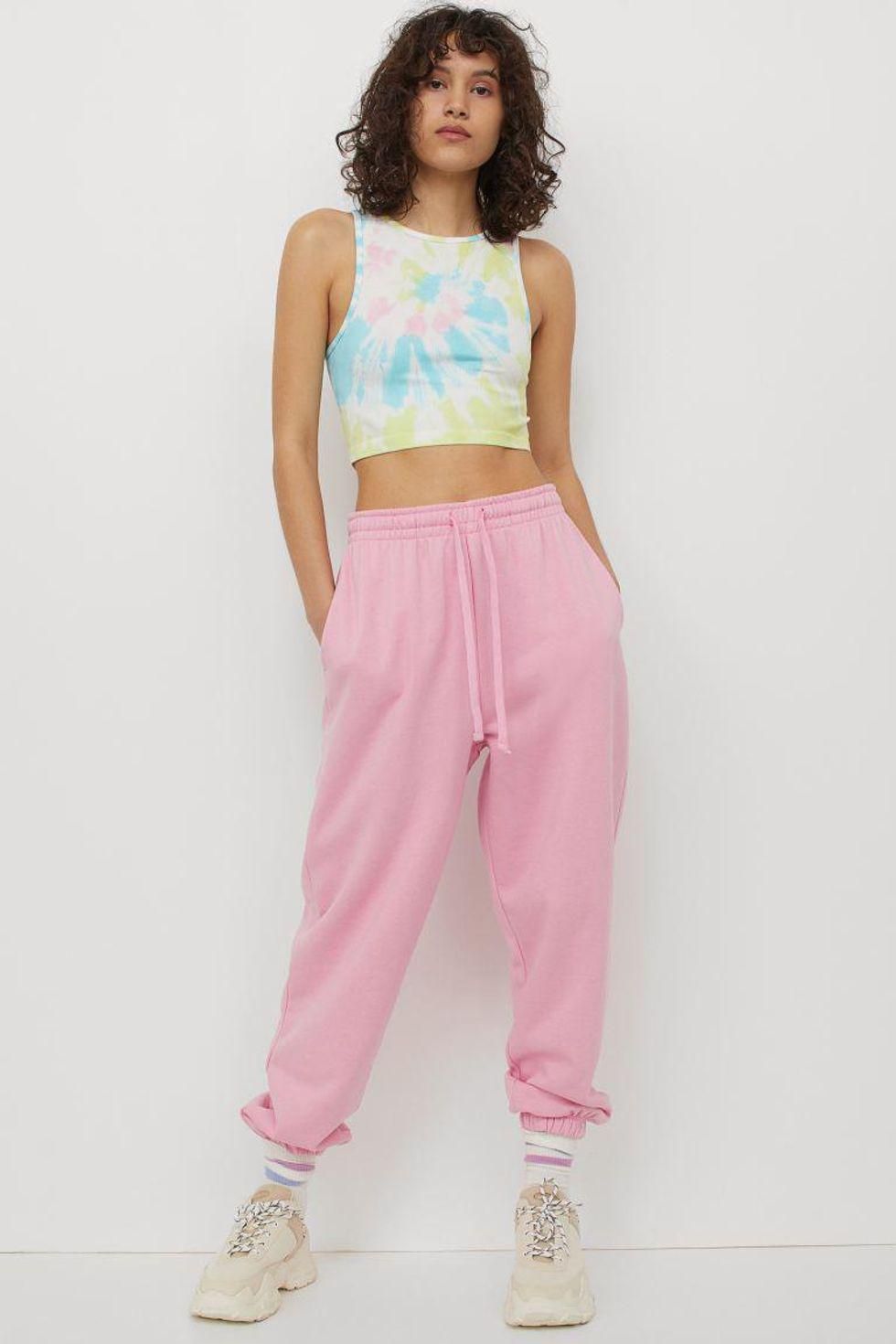 model wears pink joggers with white sneakers and tie dye tank