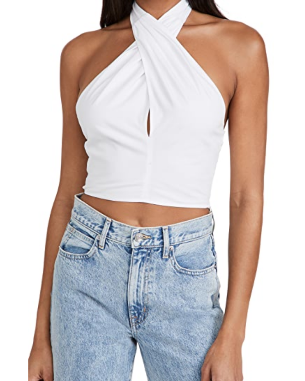 model wears Staud Kai Top with high rise acid wash jeans