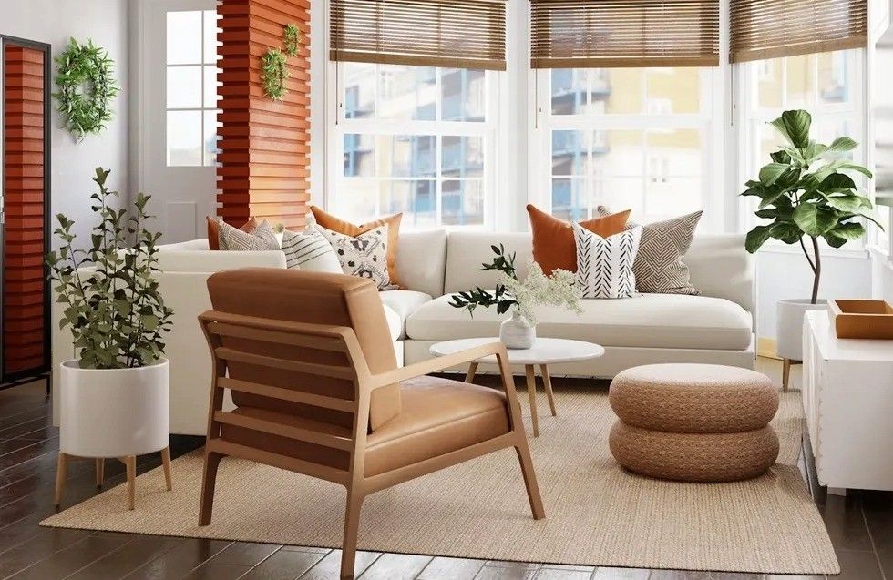 Modern living room with white sofa, wooden chair, plants, and large windows.