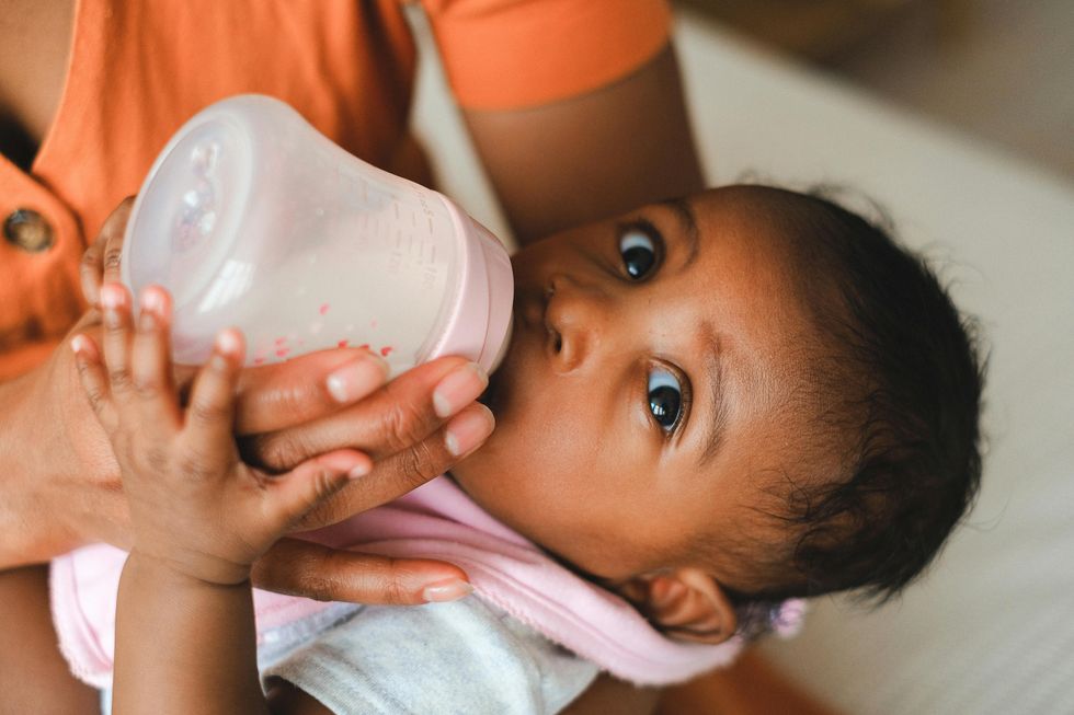 mom bottle feeding baby