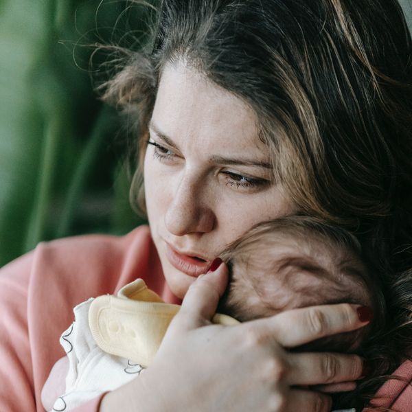 mom holding crying infant