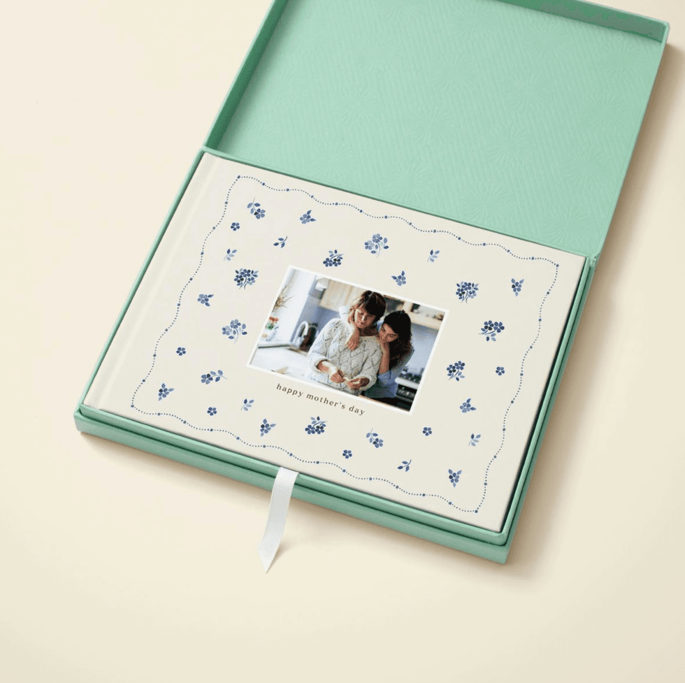 Mother's Day photo book in blue floral box, featuring a warm family image.
