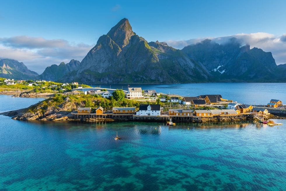 Mountains rise behind a settlement in the Lofoten archipelago