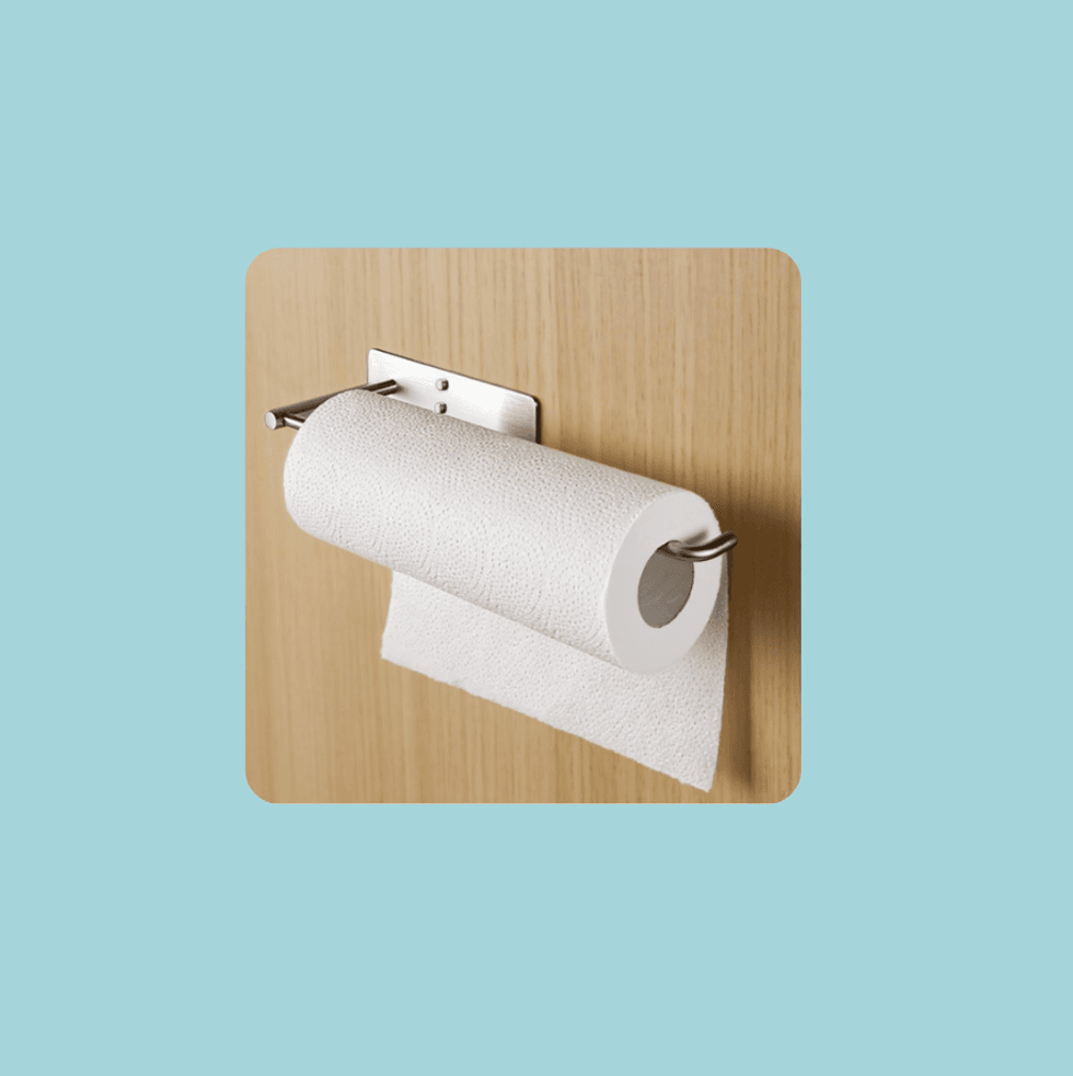 Mounted toilet paper roll on wooden wall against a light blue background.