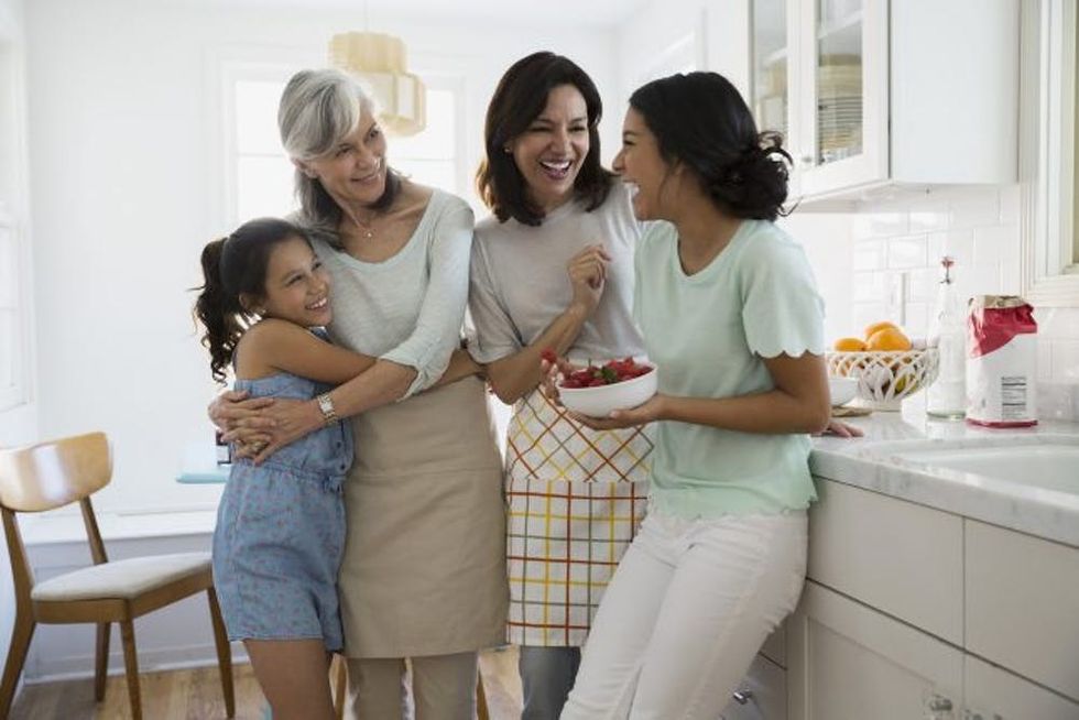 Multi-generation women laughing in kitchen