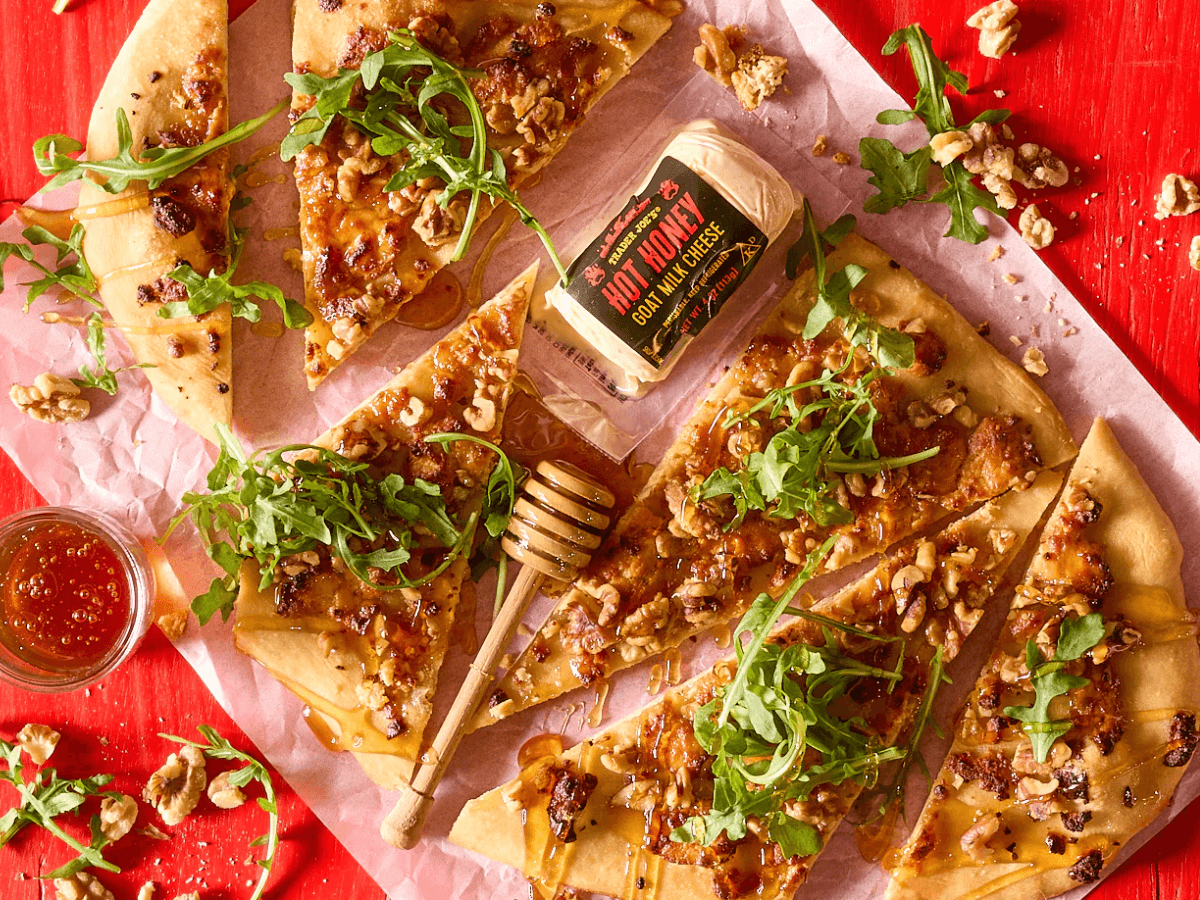 New ​​Trader Joe's items for February 2026 include new spa items like body oil and body scrub, sweet snacks like chocolate biscuit cookies, and cheesy options like dill dip and Unexpected Cheddar Snackers.