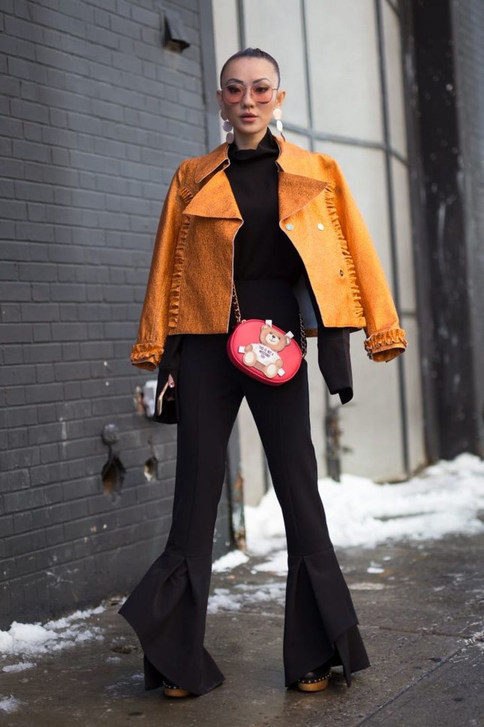 NEW YORK, NY - FEBRUARY 10: Jessica Wang is seen attending MILLY during New York Fashion Week wearing an orange jacket and all-black outfit on February 10, 2017 in New York City. (Photo by Matthew Sperzel/Getty Images)