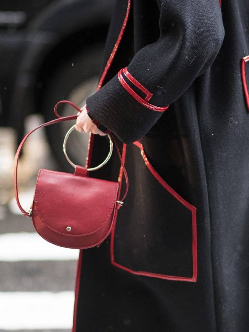 NEW YORK, NY - FEBRUARY 12: A guest seen wearing a coat with red lines and a red bag in the streets of Manhattan after the Victoria Beckham show during the New York Fashion Week February 2017 on February 12, 2017 in New York City. (Photo by Timur Emek/Getty Images)