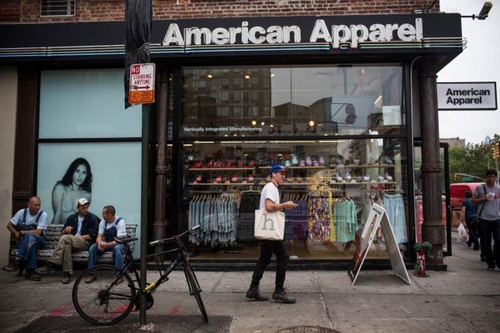NEW YORK, NY - JUNE 19: People walk past an American Apparel store on June 19, 2014 in New York City. American Apparel's board has voted to remove the company's controversial CEO, Dov Charney. (Photo by Andrew Burton/Getty Images)