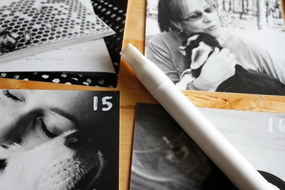 Number each month with the white paint pen. Attach the prints using Sticky Tack \u2013 you can easily move them around month to month.