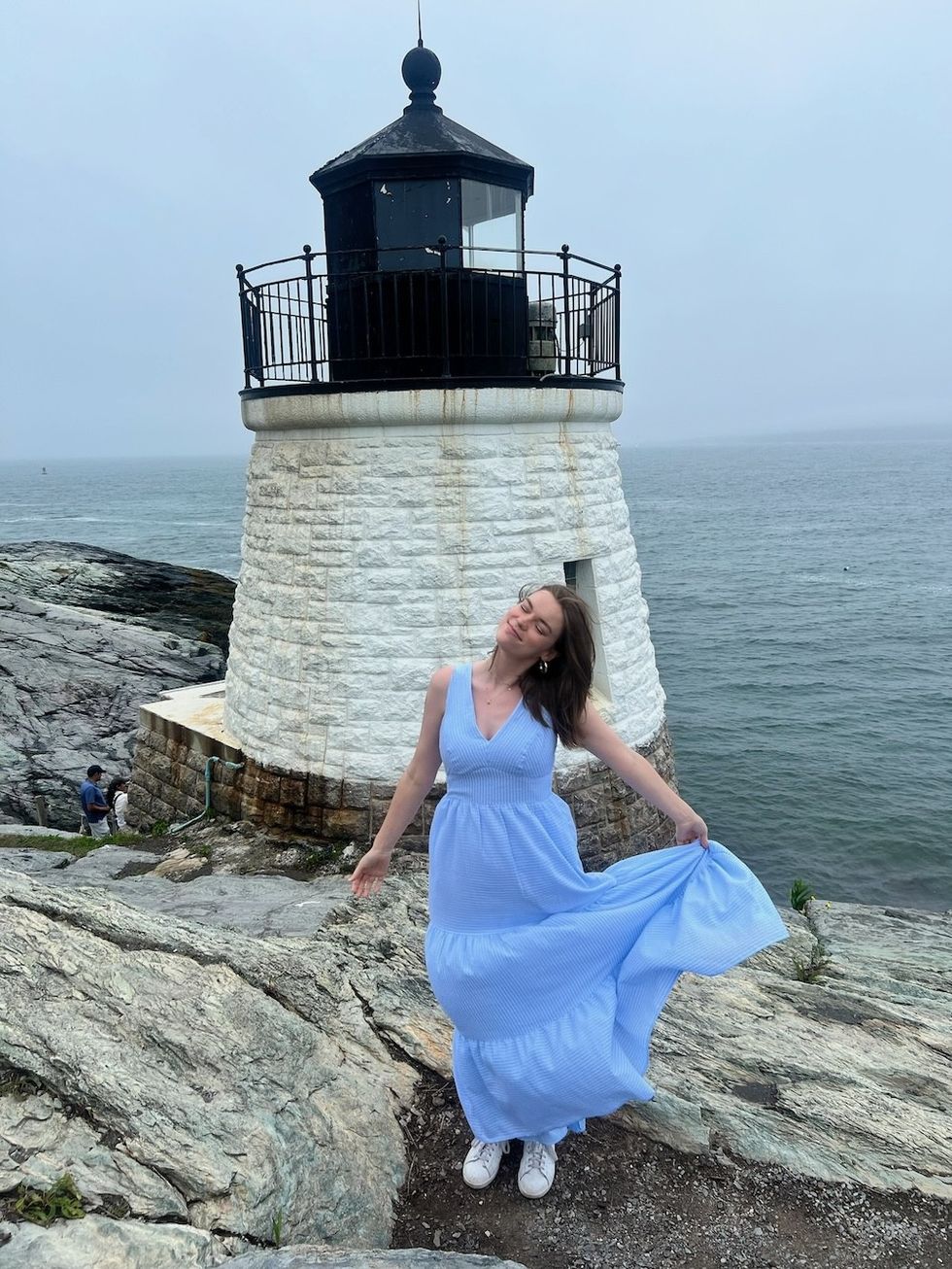 old lighthouse against the ocean in newport