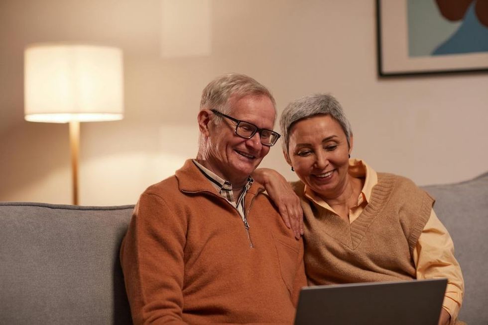 older couple doing trivia on their computer