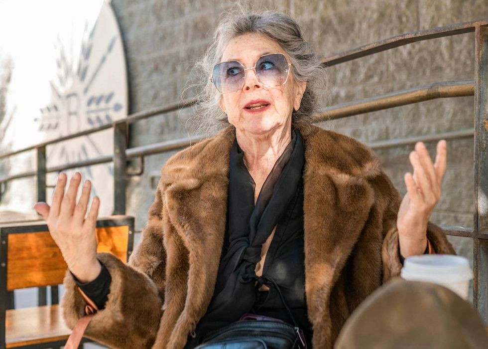 older woman in sunglasses and a fur coat