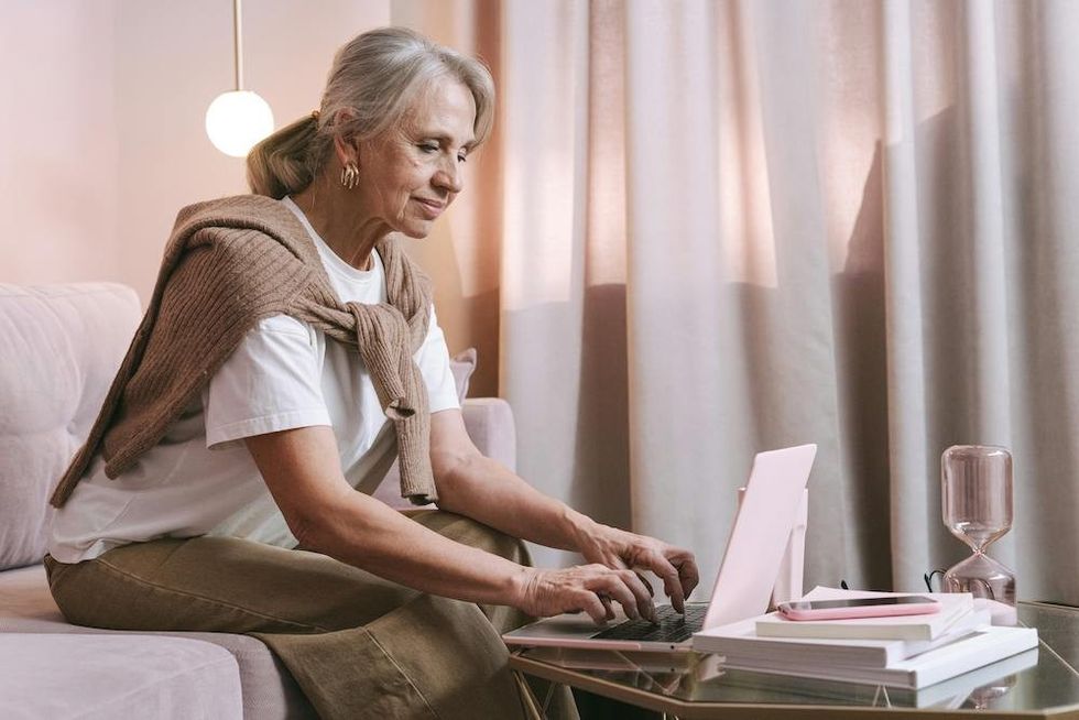 older woman learning a new language on her laptop