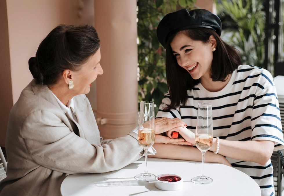 older woman sitting at the table with a younger woman