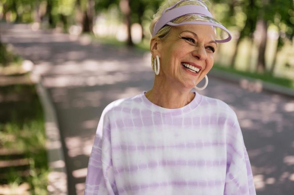older woman wearing pastel purple