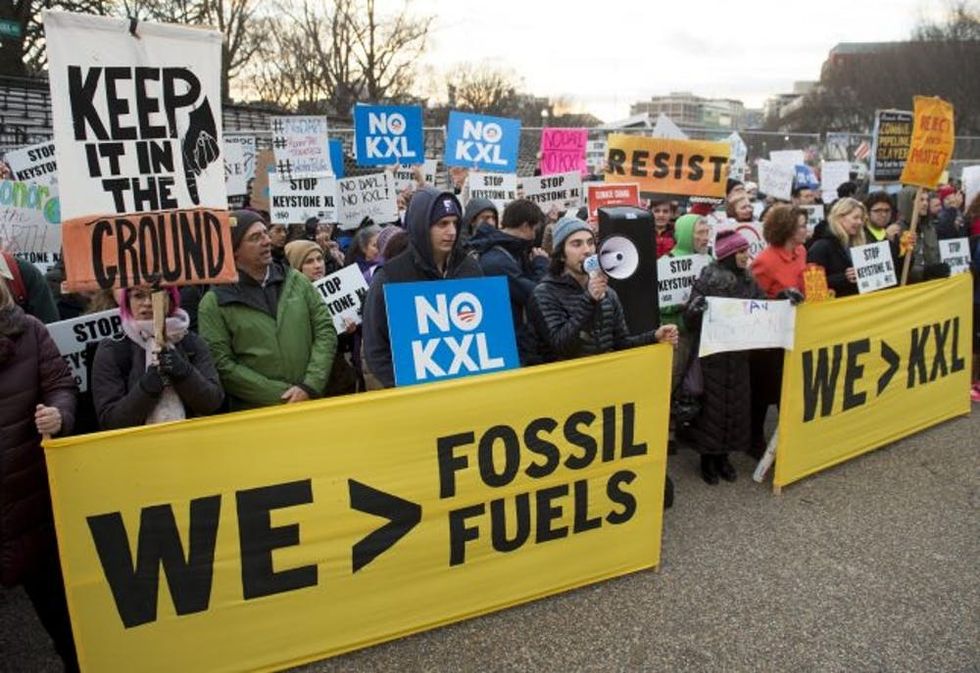 Opponents of the Keystone XL and Dakota Access pipelines hold a rally as they protest US President Donald Trump's executive orders advancing their construction, at Lafayette Park next to the White House in Washington, DC, on January 24, 2017. US President Donald Trump signed executive orders Tuesday reviving the construction of two controversial oil pipelines, but said the projects would be subject to renegotiation. / AFP / SAUL LOEB (Photo credit should read SAUL LOEB/AFP/Getty Images)