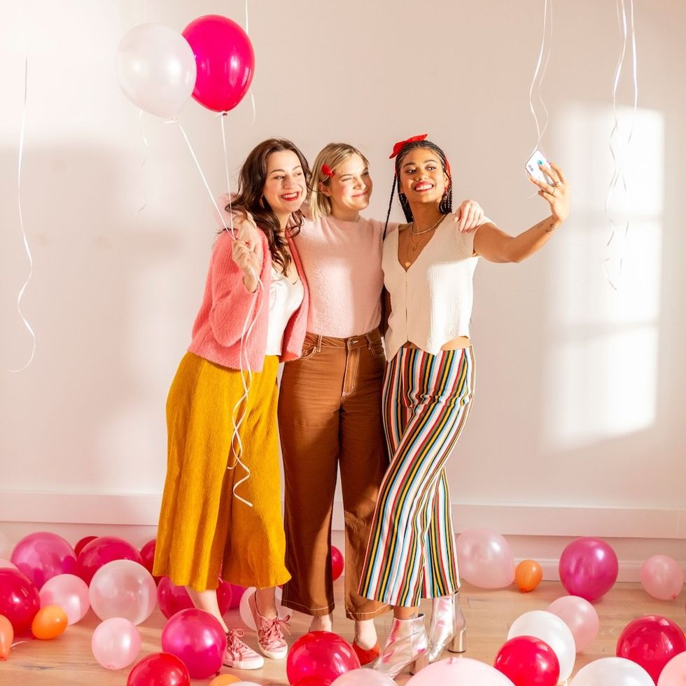 optimistic friends taking a selfie surrounded by balloons how to make friends as an adult