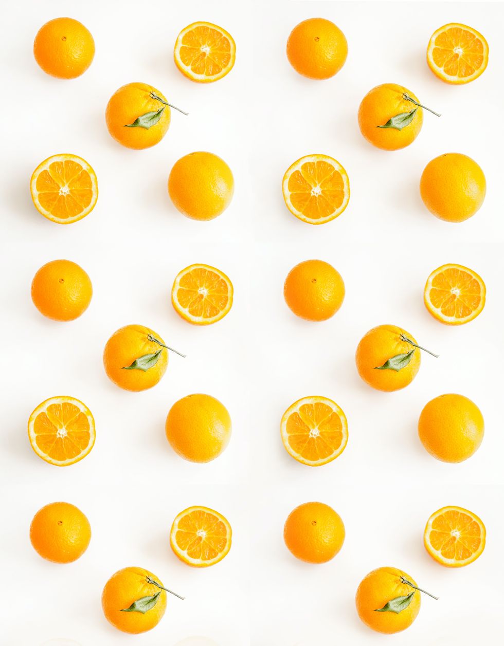 orange fruits and orange slices arranged on a white background