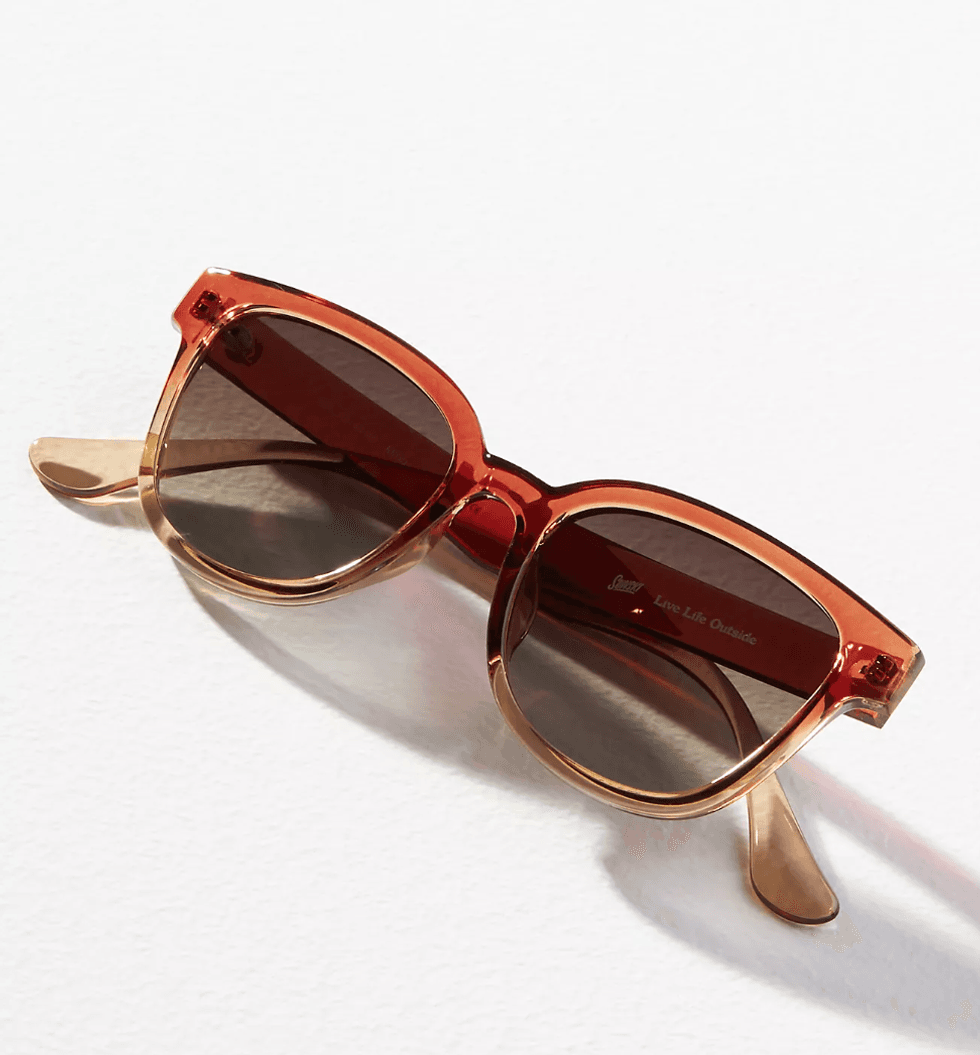 Orange gradient sunglasses on a white surface.