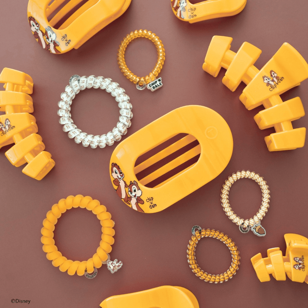 Orange hair accessories with characters on a brown background.