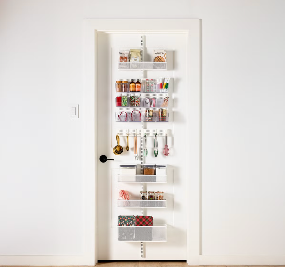 Organized pantry door with shelves holding jars, utensils, and containers.