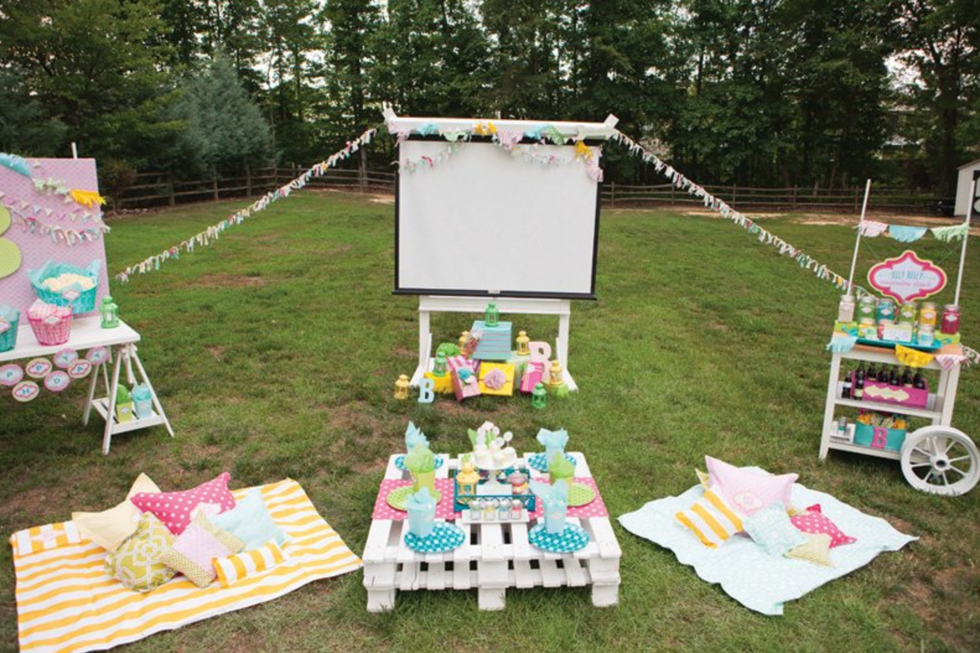 outdoor movie night party with blankets and snacks and pillows