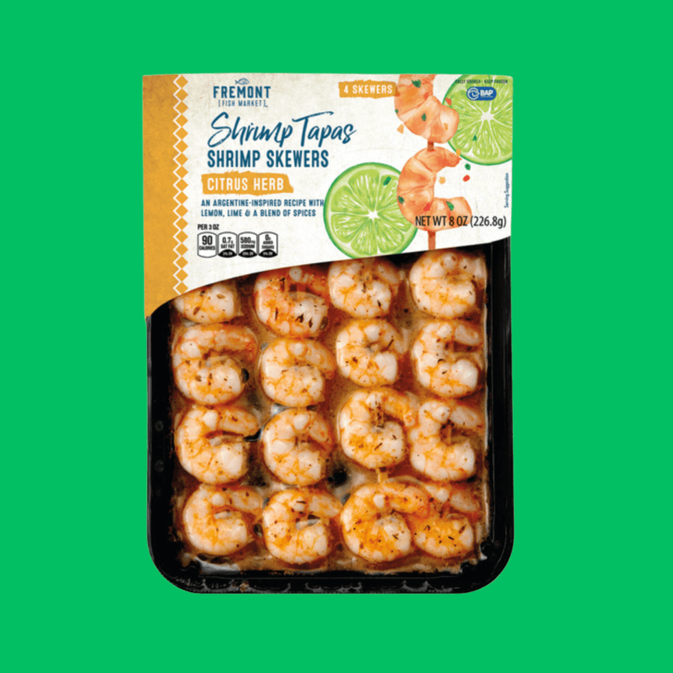 Packaged citrus herb shrimp skewers from Fremont Fish Market on a green background.