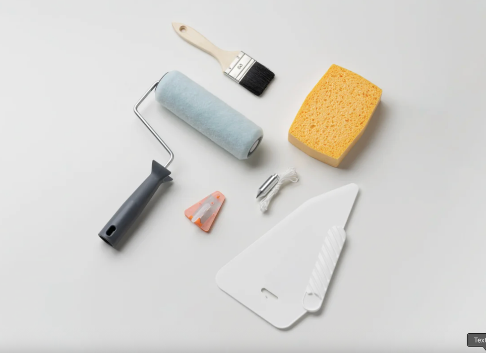 Painting tools: roller, brush, sponge, scraper, blades, and masking tape on white background.