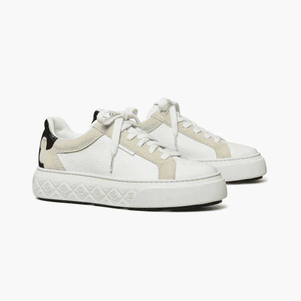 Pair of white leather sneakers with beige accents, black heel details, and thick patterned soles.