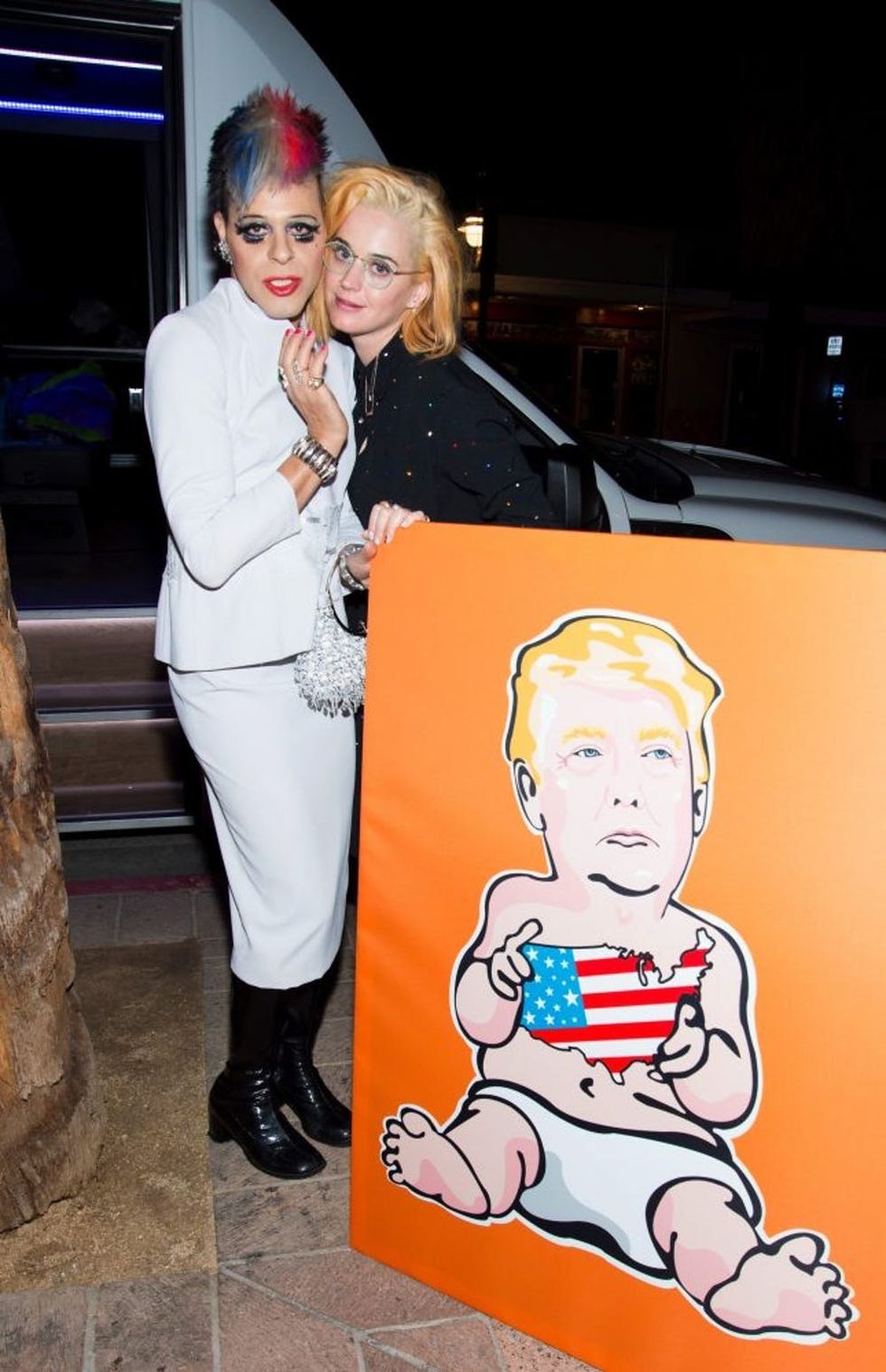 PALM SPRINGS, CA - JANUARY 14: TV Personality/pop artist Sham Ibrahim and singer Katy Perry pose for a photo with a Donald Trump portrait at Oscar's on January 14, 2017 in Palm Springs, California. (Photo by Tara Ziemba/Getty Images)
