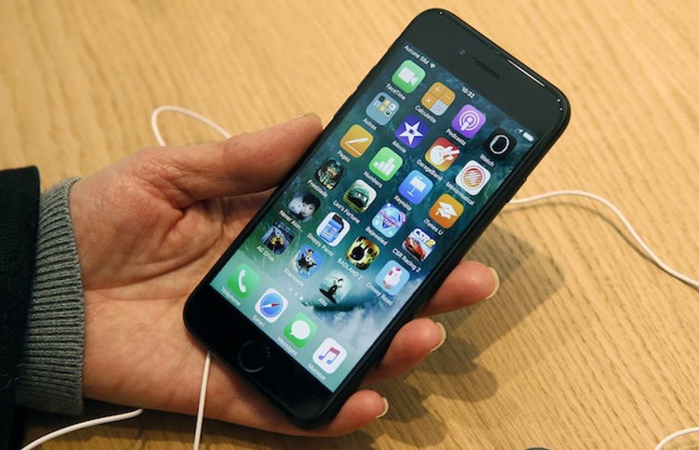PARIS, FRANCE - DECEMBER 03: A customer checks an iPhone 7 inside the new Apple store Saint-Germain during the first opening day on December 03, 2016 in Paris, France. This store employs 120 people and has an area of 1,300 m2, it is the largest in the capital and it is the first in France to embrace the new design codes chosen by Apple for its shops. Apple store Marche Saint-Germain is the third store in Paris, the 20th in France and the 110th in Europe and will be the 489th in the world. (Photo by Chesnot/Getty Images)