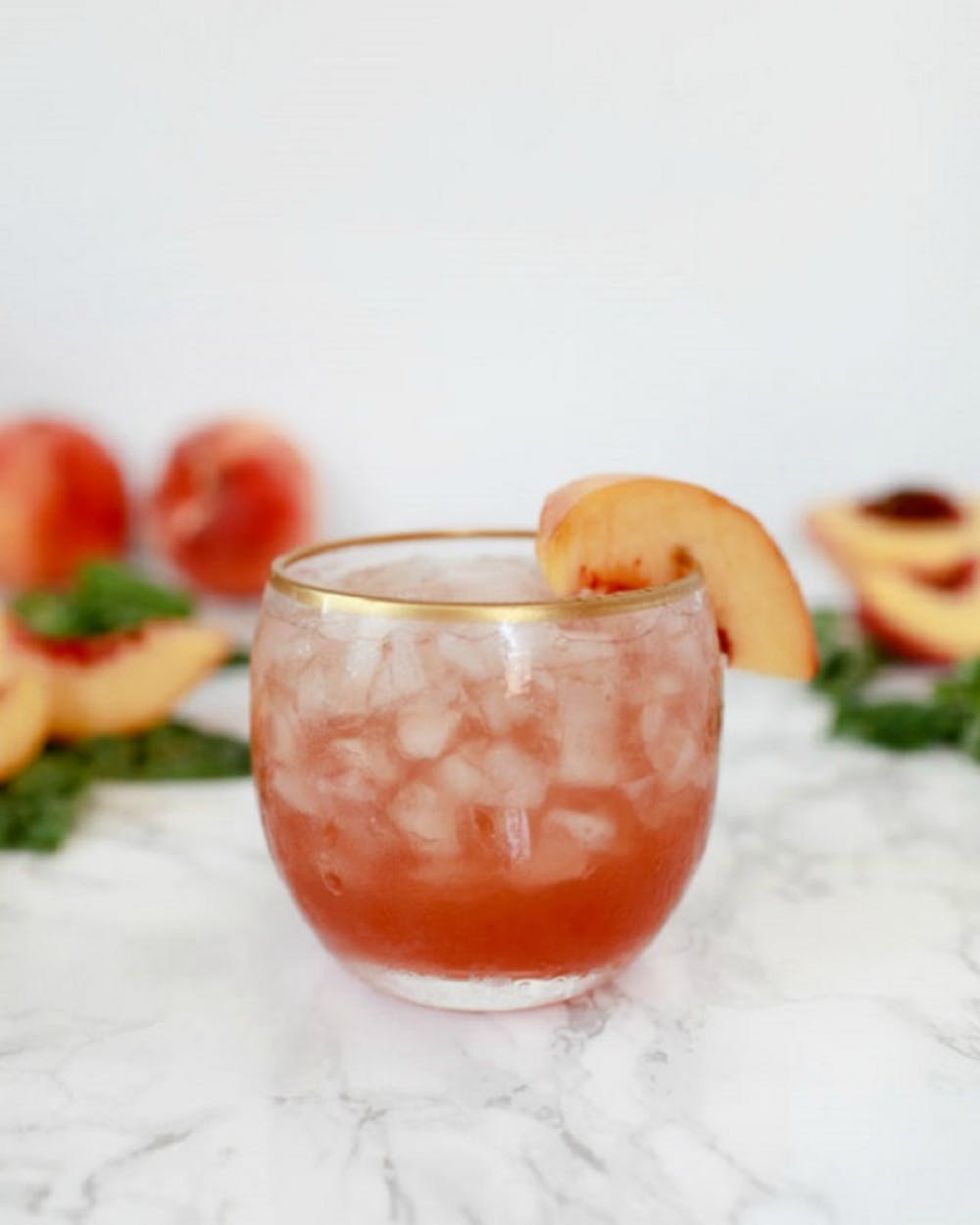 Peach-Basil Shrub Cocktail with peach slice