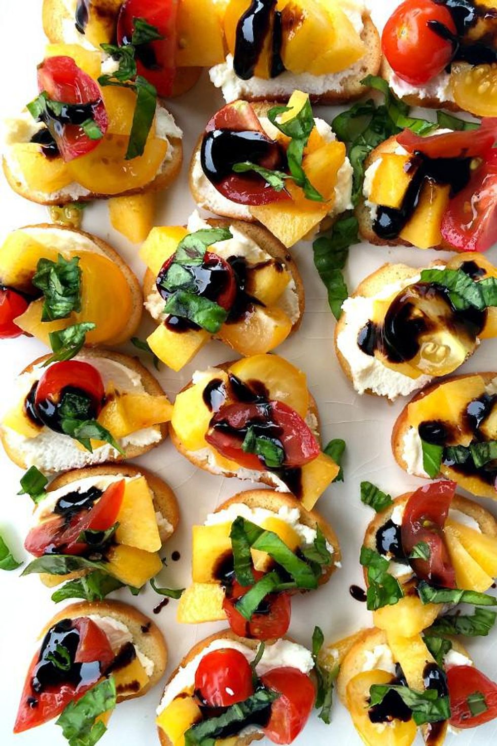 Peach, tomato, basil, balsamic glaze on crostini