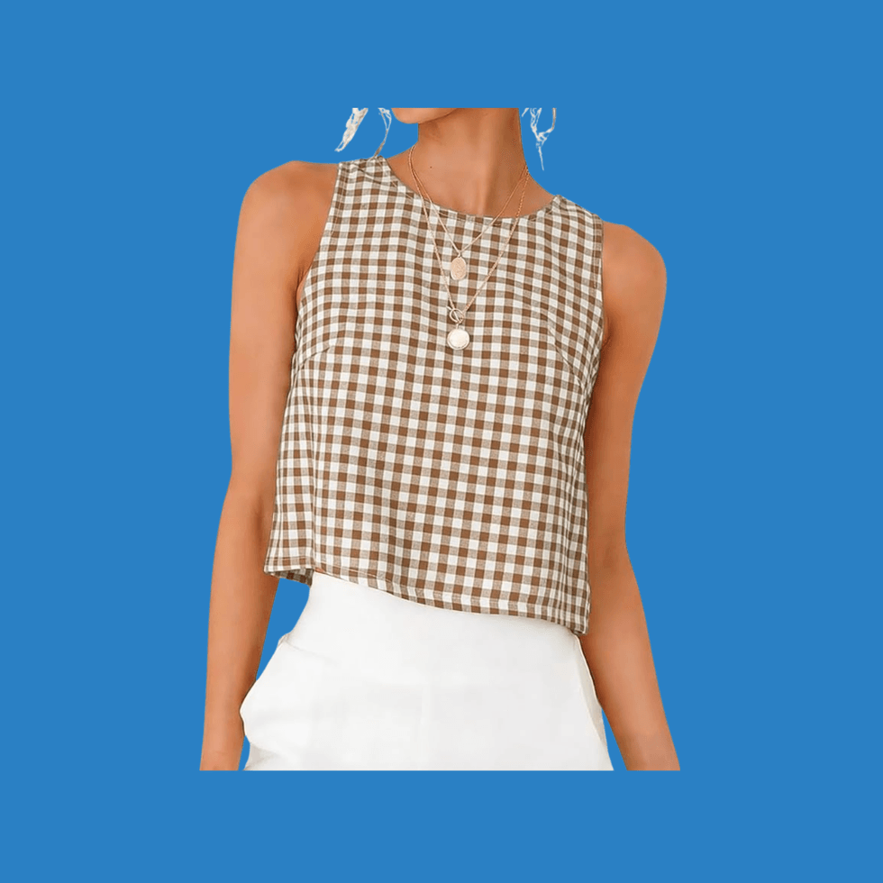 Person in checkered top and white pants against a blue background.