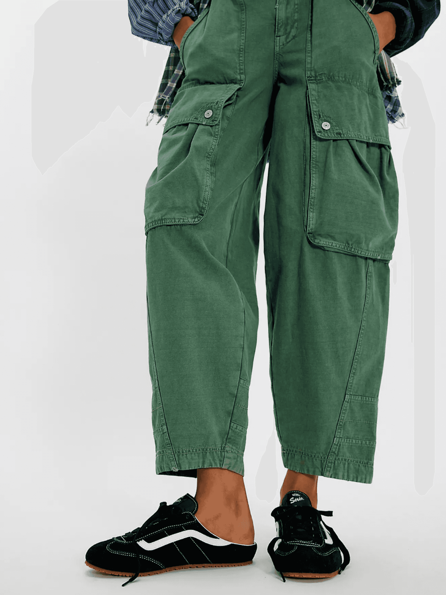 Person in green cargo pants and black sneakers with white stripes.