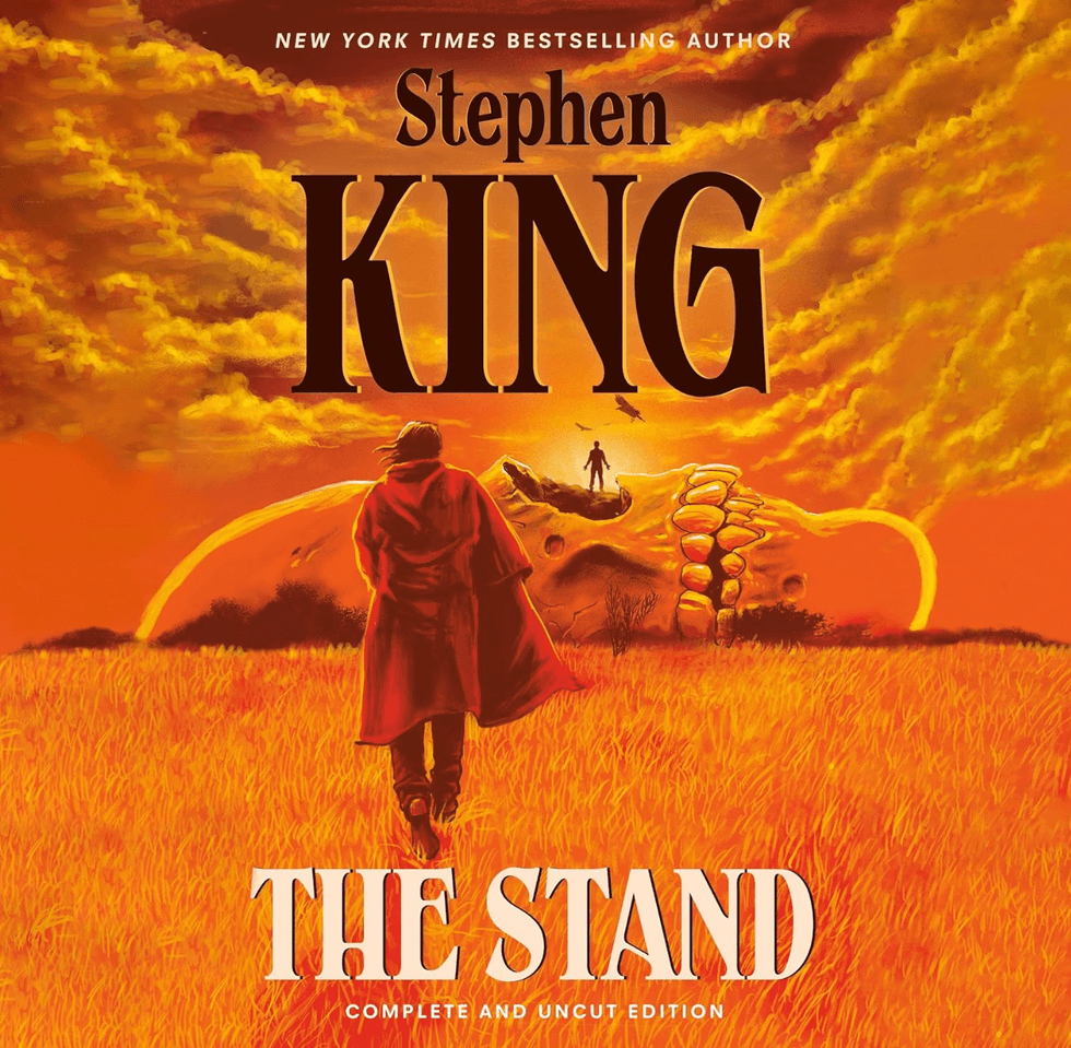 Person in red coat in field with skeletal hand in background, "The Stand" cover.