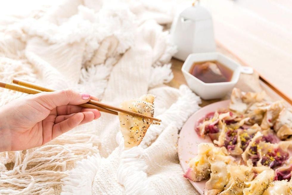 picking up the food with chopsticks