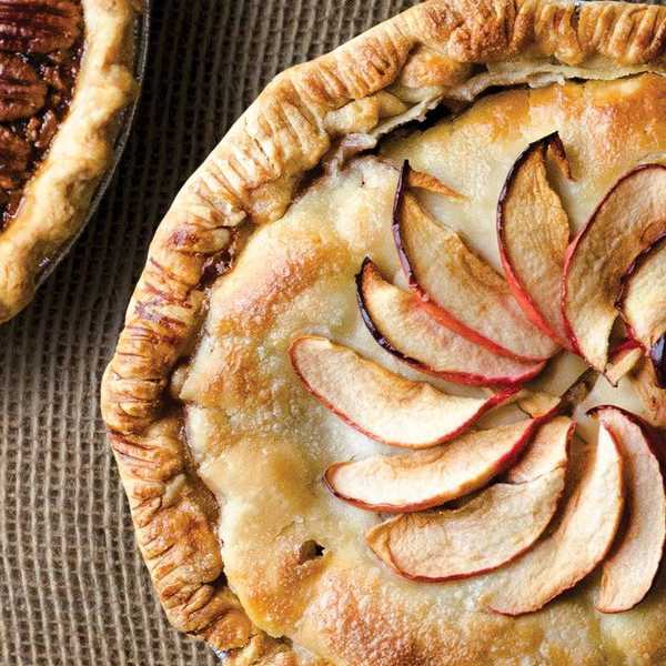 pie with plum slices arranged in a fanned circle on top
