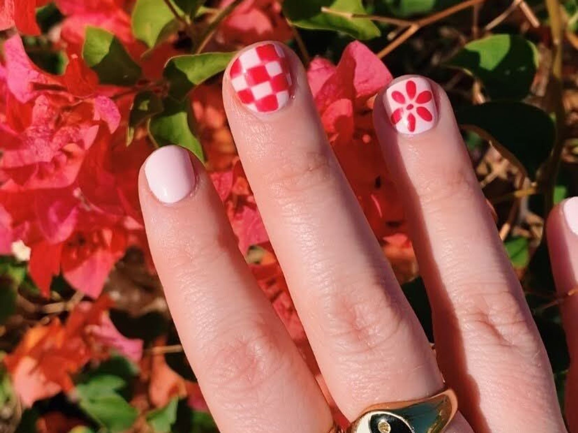 pink checkerboard and floral nail design