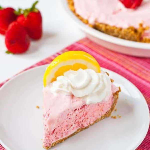 pink frozen strawberry lemonade pie with lemon on top